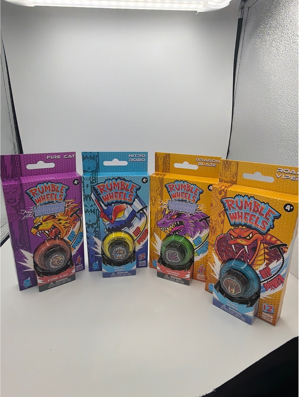 Rumble Wheels Combo 4-Pack Lightning Strikers Dragon Blaze & Fire Cat + Core Rac